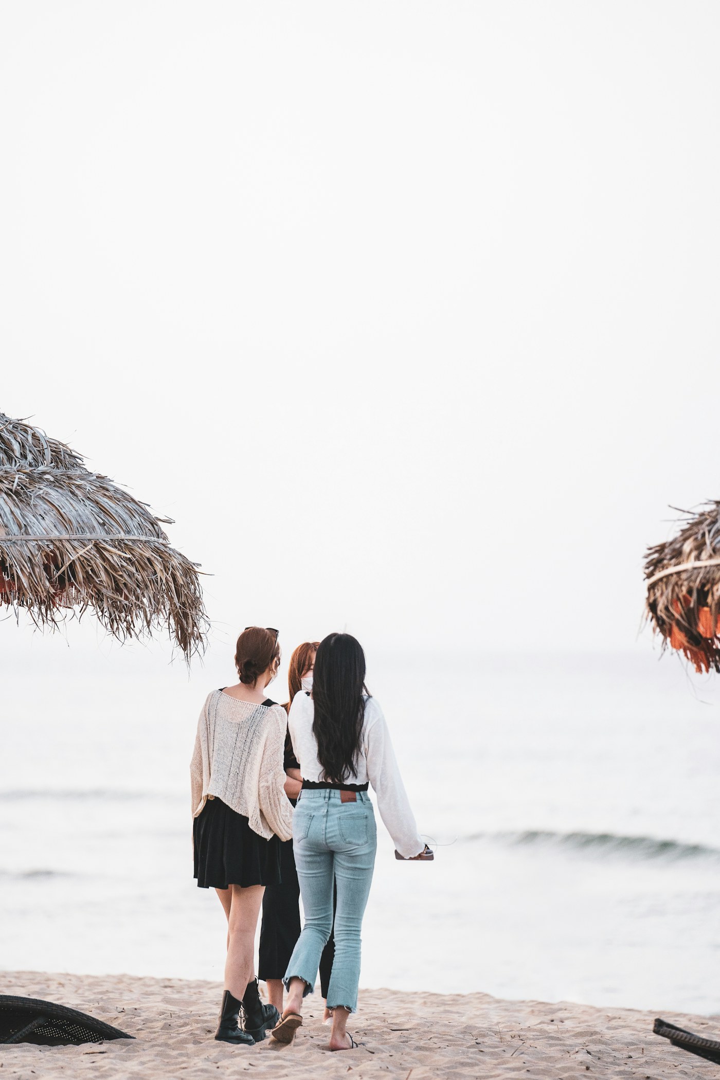 Two friends standing together beside the sea
