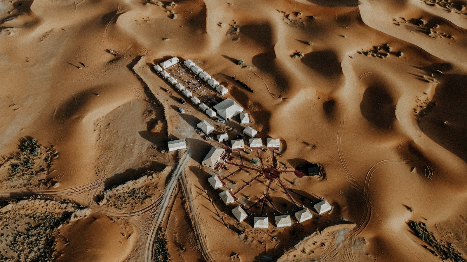 An aerial view of a small camp among Morocco's desert dunes