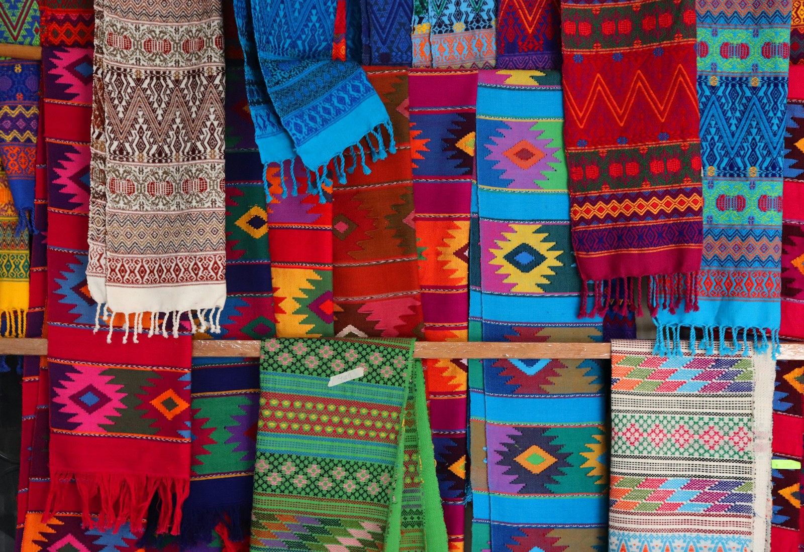 Brightly coloured woven textiles at a market in Oaxaca